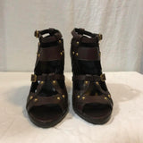 Dark brown Gucci heels with gold embellishments