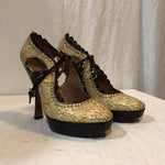 Heeled snake skin pumps from Alaïa with black flower trim and two fastenings